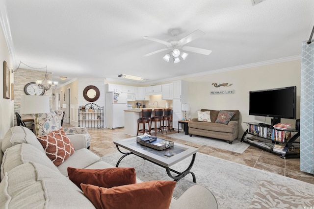 living room with ceiling fan with notable chandelier and crown molding