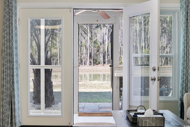 doorway featuring a water view and ceiling fan