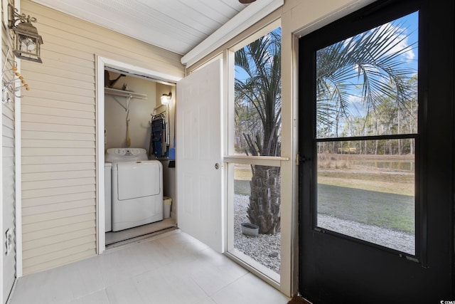 laundry room featuring tile patterned floors, laundry area, and washing machine and clothes dryer