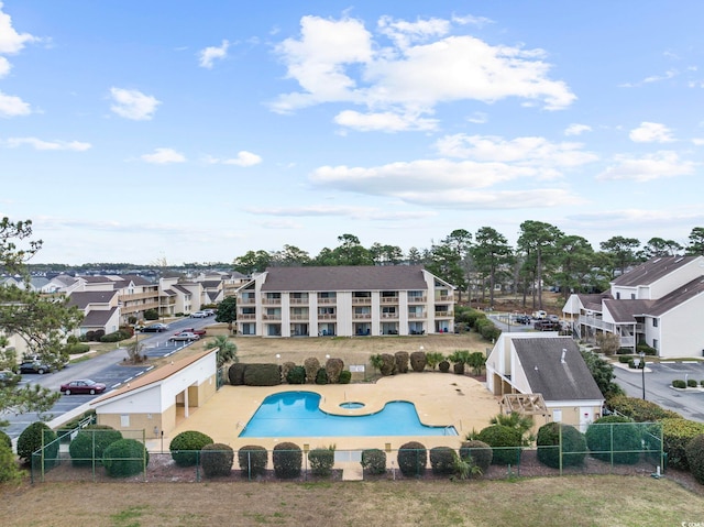 back of house featuring a patio, a fenced backyard, and a community pool