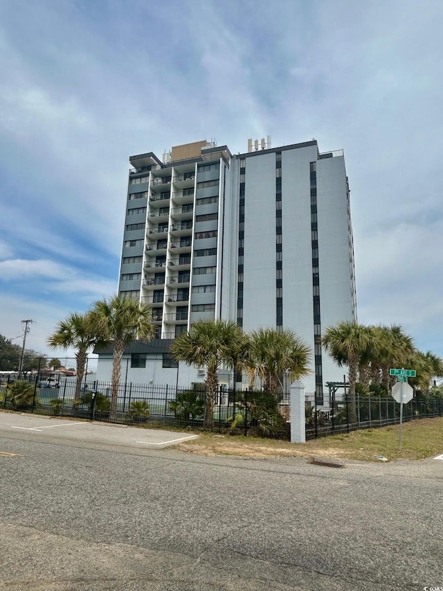 view of building exterior featuring a fenced front yard