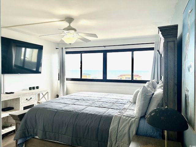 bedroom featuring a ceiling fan and wood finished floors