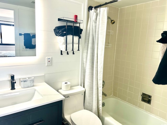 full bathroom with shower / bath combo with shower curtain, toilet, and vanity