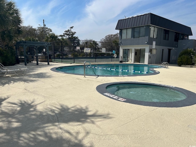 community pool with a patio, a community hot tub, fence, and a pergola