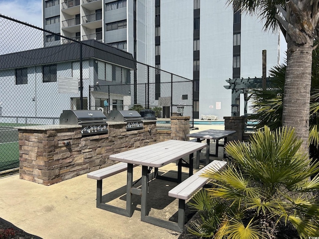 view of patio featuring grilling area, area for grilling, and fence