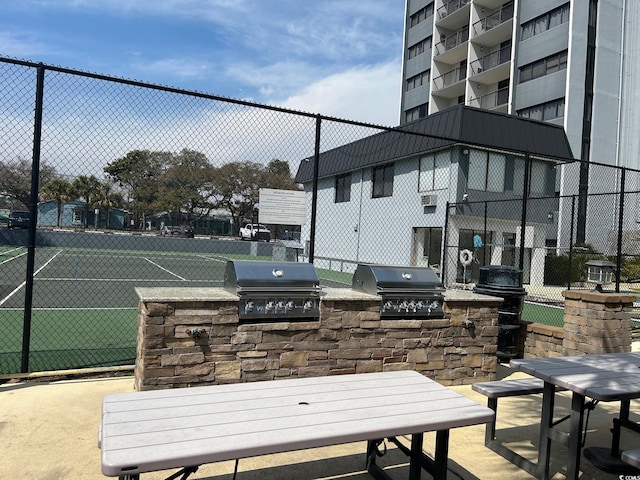 view of patio with a grill, exterior kitchen, and fence