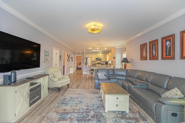 living area featuring ornamental molding and light wood finished floors