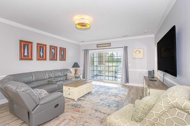 living area featuring baseboards, light wood-style flooring, and crown molding