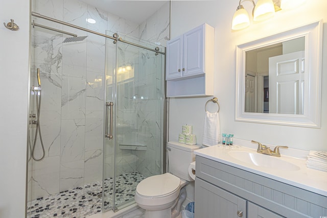 bathroom with a marble finish shower, marble finish floor, toilet, and vanity