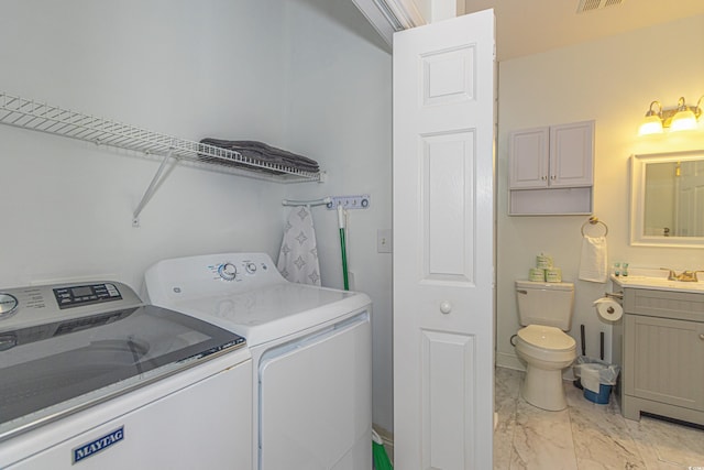 laundry room featuring visible vents, marble finish floor, washer and clothes dryer, a sink, and laundry area