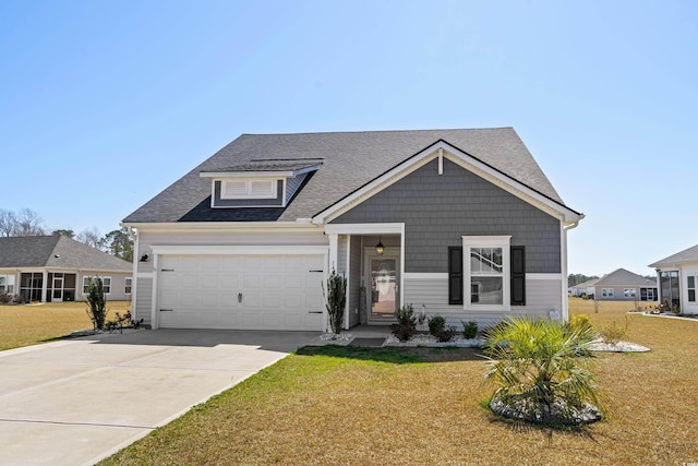 view of front facade with an attached garage, concrete driveway, a front yard, and a shingled roof