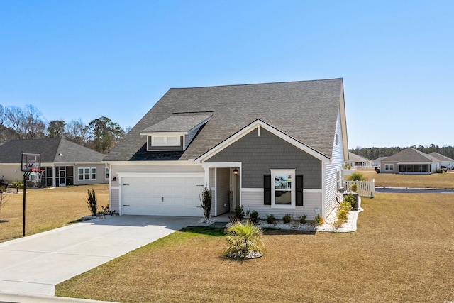 view of front facade featuring a front yard, concrete driveway, an attached garage, and roof with shingles