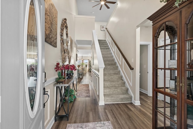 entryway featuring stairway, a ceiling fan, dark wood-style floors, french doors, and a towering ceiling