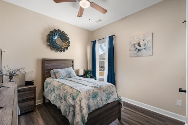 bedroom featuring visible vents, a ceiling fan, baseboards, and dark wood-style flooring