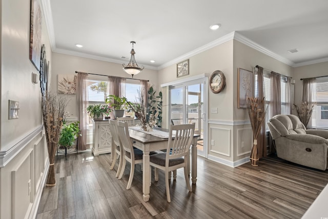 dining space with a wainscoted wall, crown molding, and dark wood-type flooring