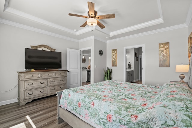 bedroom featuring a raised ceiling, ornamental molding, a ceiling fan, wood finished floors, and baseboards