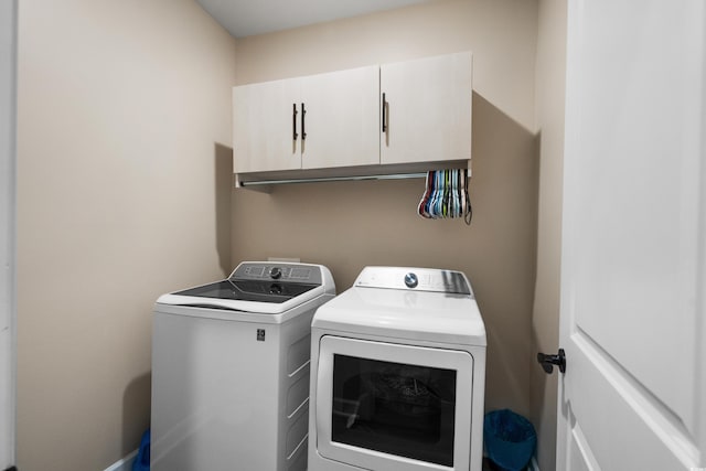 laundry area with cabinet space and separate washer and dryer