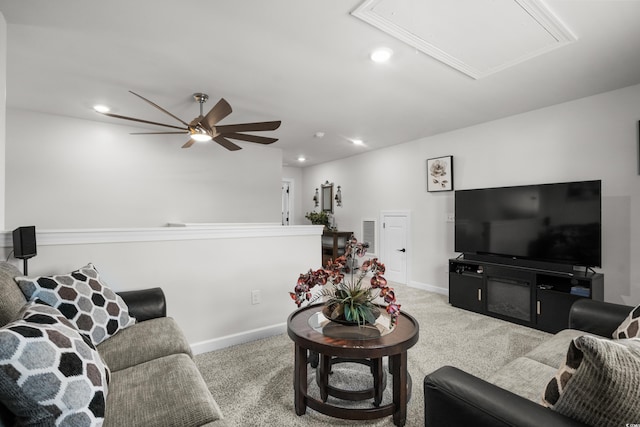 living room with recessed lighting, ceiling fan, attic access, and carpet