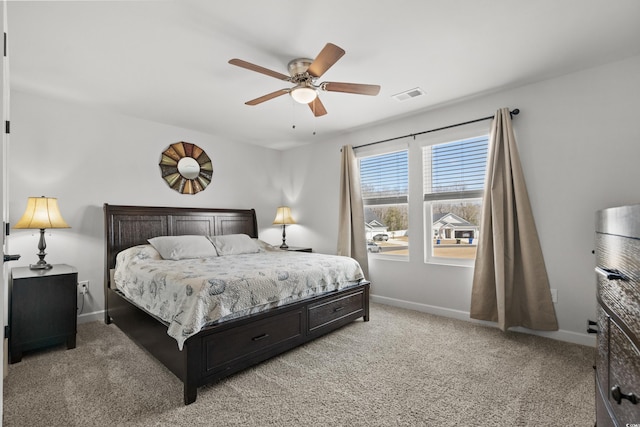 bedroom featuring visible vents, baseboards, light colored carpet, and a ceiling fan