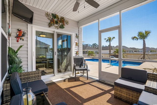 sunroom featuring ceiling fan