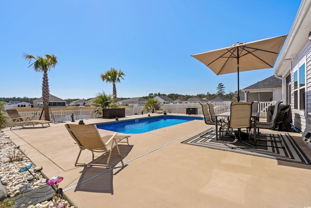 view of swimming pool with a fenced in pool, a patio, a fenced backyard, and outdoor dining space