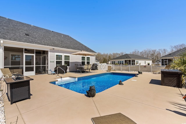 view of pool with a patio, a fenced backyard, a fenced in pool, and a sunroom