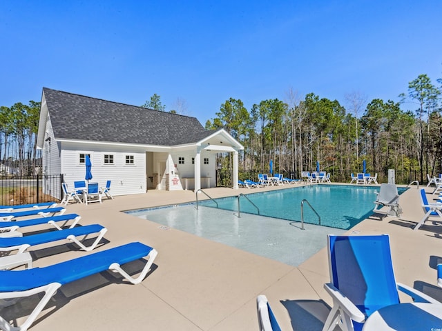 community pool featuring a patio area and fence