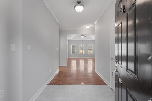 entrance foyer featuring light tile patterned flooring, baseboards, crown molding, and ceiling fan