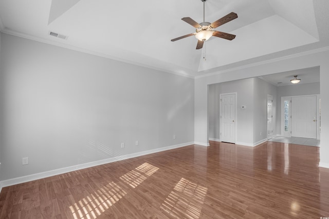 spare room with visible vents, wood finished floors, baseboards, and ceiling fan