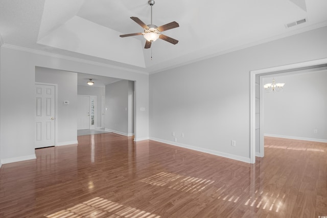 unfurnished living room featuring visible vents, a raised ceiling, wood finished floors, and ceiling fan with notable chandelier