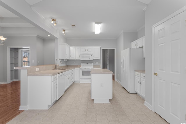 kitchen featuring white appliances, light floors, a peninsula, a sink, and light countertops