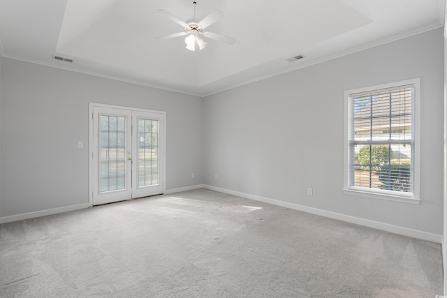 1019 Hillsdale Dr, Little River, SC 29566 - empty room with a tray ceiling, ornamental molding, a ceiling fan, french doors, and light colored carpet