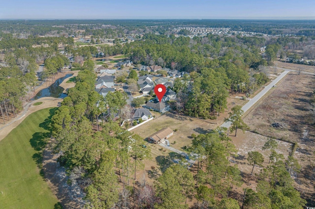 birds eye view of property with a wooded view