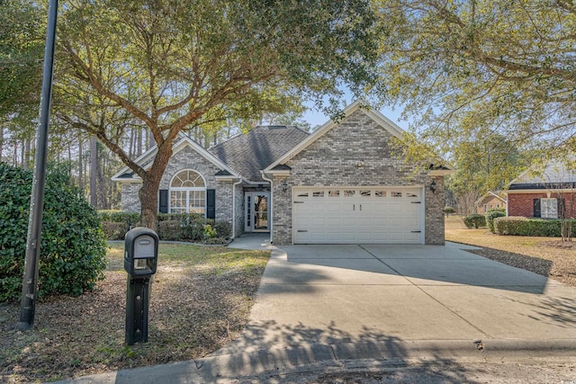 1019 Hillsdale Dr, Little River, SC 29566 - traditional-style house with a garage, driveway, and brick siding