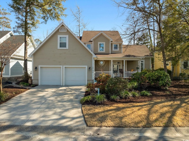 view of front of home with an attached garage, covered porch, driveway, and roof with shingles