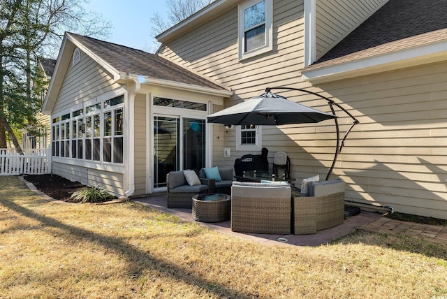 rear view of house featuring fence, roof with shingles, an outdoor hangout area, a yard, and a patio