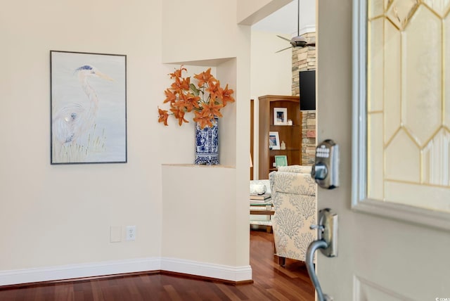 interior space featuring dark wood-style floors, baseboards, and a ceiling fan