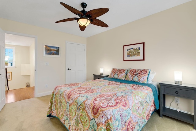 carpeted bedroom featuring a ceiling fan and baseboards