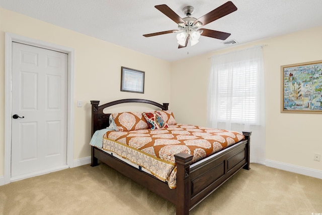 bedroom with light carpet, visible vents, and baseboards