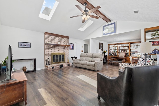 living area with visible vents, beamed ceiling, a skylight, and a ceiling fan