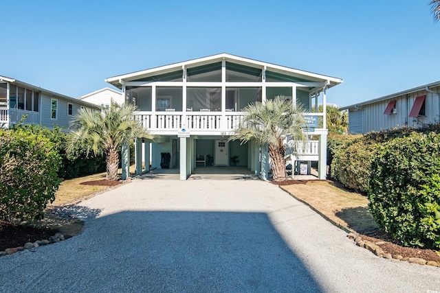162 Norris Dr, Pawleys Island, SC 29585 - coastal home with a carport, driveway, and a sunroom