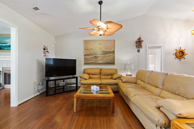 living area with visible vents, dark wood-type flooring, a ceiling fan, baseboards, and vaulted ceiling