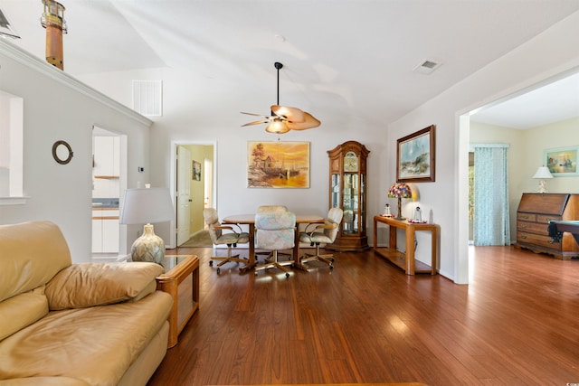 living area with dark wood-style floors, visible vents, lofted ceiling, and a ceiling fan