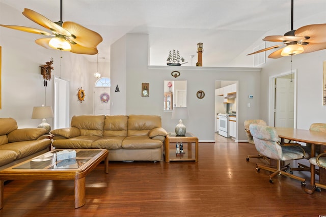 living room with baseboards, wood finished floors, a ceiling fan, and vaulted ceiling