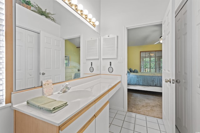 bathroom featuring tile patterned flooring, ensuite bathroom, a closet, vanity, and a ceiling fan