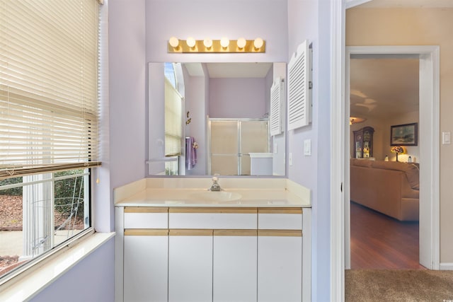 bathroom with an enclosed shower, ensuite bath, and vanity