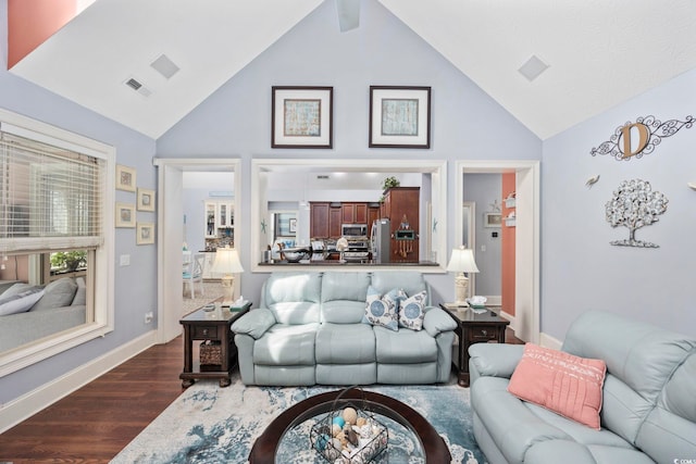 living room with visible vents, baseboards, dark wood-type flooring, and high vaulted ceiling