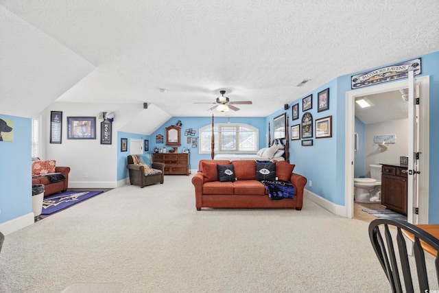 living room with visible vents, carpet floors, baseboards, and a ceiling fan