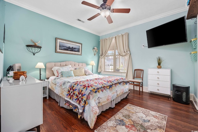 bedroom featuring visible vents, crown molding, baseboards, ceiling fan, and wood finished floors