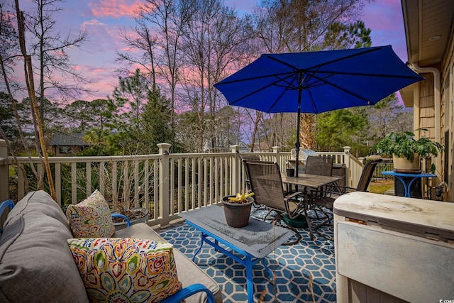 deck with outdoor dining area